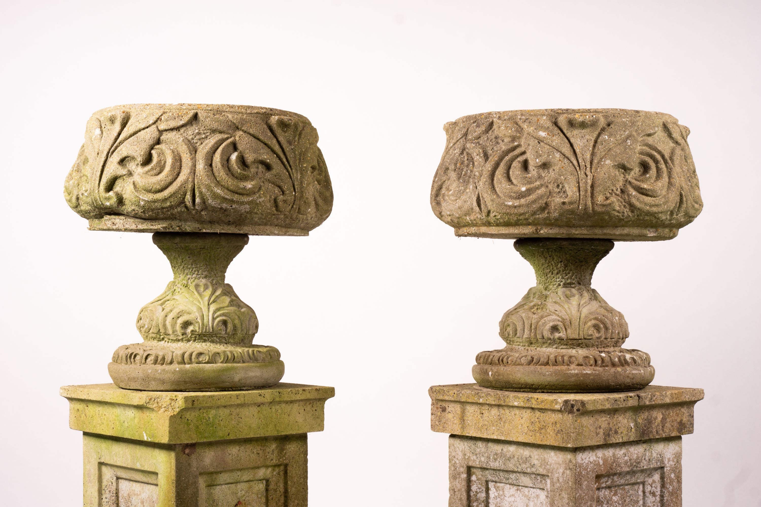 A pair of reconstituted stone circular garden planters on pedestal bases, diameter 45cm, height 110cm